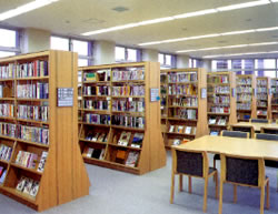 きれいに陳列された本棚と、読書スペースの椅子と机が置かれた書架コーナーの写真